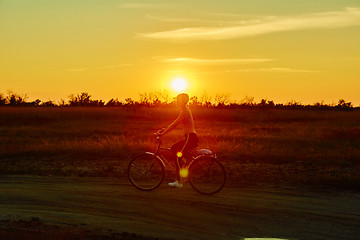 Image showing Biker-girl at the sunset