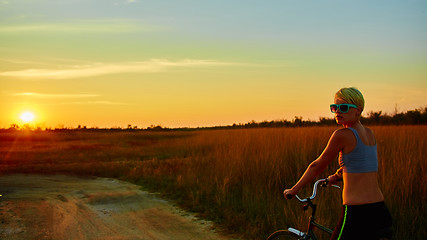 Image showing Biker-girl at the sunset