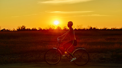 Image showing Biker-girl at the sunset