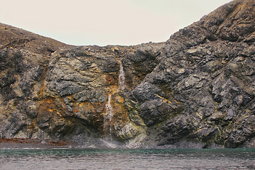 Image showing Rocky cliffs of Novaya Zemlya archipelago in Barents sea and waterfalls