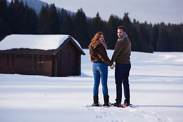 Image showing couple having fun and walking in snow shoes