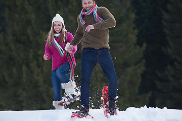 Image showing couple having fun and walking in snow shoes