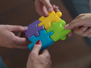 Image showing business people group assembling jigsaw puzzle