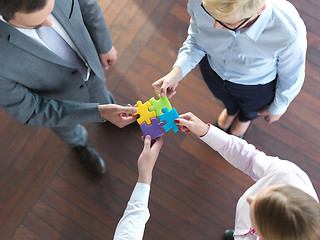 Image showing business people group assembling jigsaw puzzle