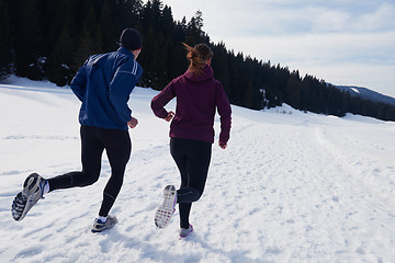 Image showing couple jogging outside on snow