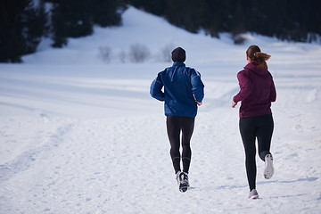 Image showing couple jogging outside on snow