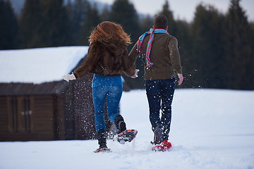 Image showing couple having fun and walking in snow shoes