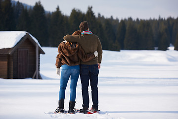 Image showing couple having fun and walking in snow shoes