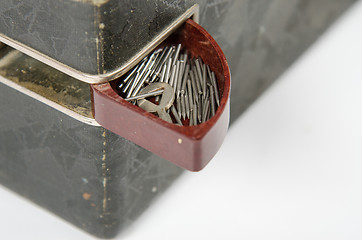 Image showing Open box with needles on the trunk of an old gramophone isolated on a white background