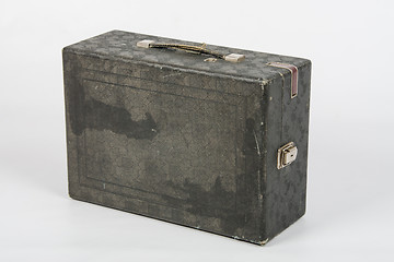Image showing Old suitcase with gramophone standing on a white background isolated