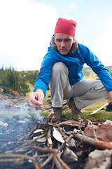 Image showing hiking man try to light fire