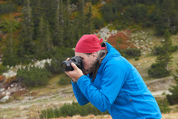 Image showing hiking man in nature taking photo