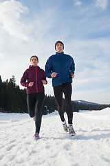 Image showing couple jogging outside on snow