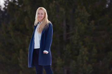 Image showing portrait of beautiful young redhair woman in snow scenery