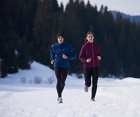 Image showing couple jogging outside on snow