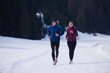 Image showing couple jogging outside on snow