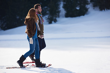 Image showing couple having fun and walking in snow shoes