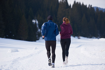 Image showing couple jogging outside on snow