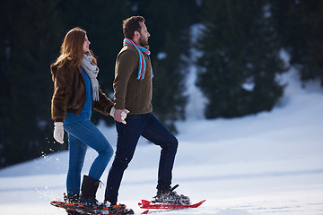 Image showing couple having fun and walking in snow shoes