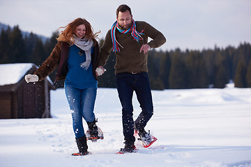 Image showing couple having fun and walking in snow shoes