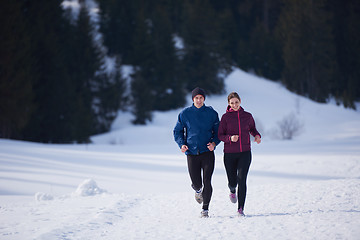 Image showing couple jogging outside on snow