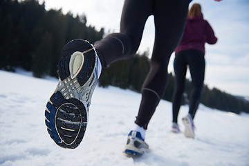 Image showing couple jogging outside on snow