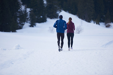 Image showing couple jogging outside on snow