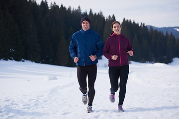 Image showing couple jogging outside on snow