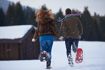 Image showing couple having fun and walking in snow shoes