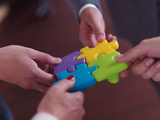 Image showing business people group assembling jigsaw puzzle