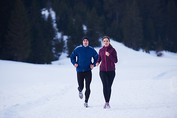 Image showing couple jogging outside on snow