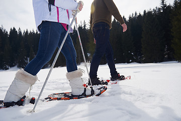 Image showing couple having fun and walking in snow shoes