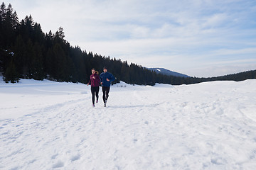 Image showing couple jogging outside on snow