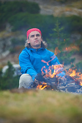 Image showing hiking man prepare tasty sausages on campfire
