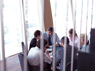 Image showing business people group on meeting at bright modern office