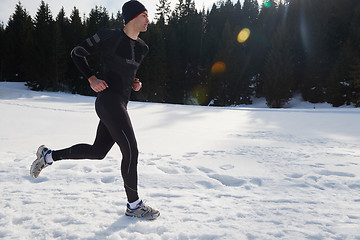 Image showing jogging on snow in forest