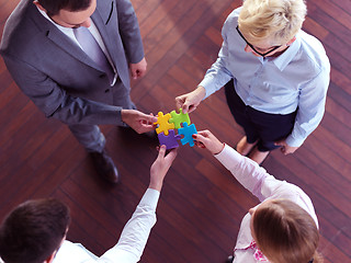 Image showing business people group assembling jigsaw puzzle