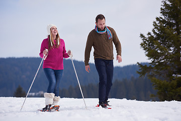 Image showing couple having fun and walking in snow shoes