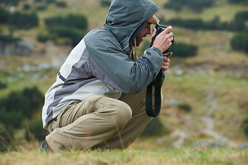 Image showing hiking man prepare tasty sausages on campfire