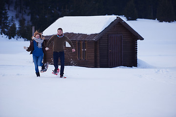 Image showing couple having fun and walking in snow shoes