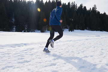 Image showing jogging on snow in forest