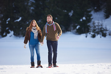 Image showing couple having fun and walking in snow shoes