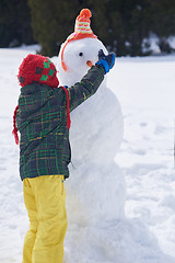 Image showing boy making snowman