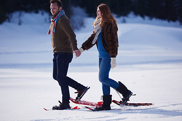 Image showing couple having fun and walking in snow shoes