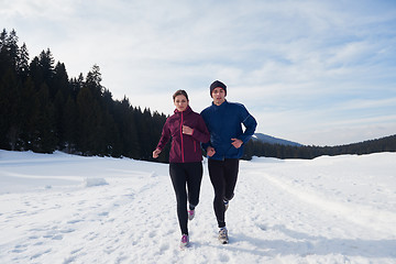 Image showing couple jogging outside on snow