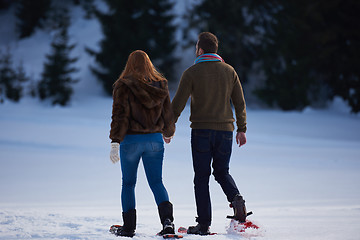 Image showing couple having fun and walking in snow shoes