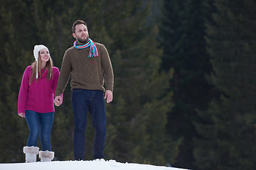 Image showing couple having fun and walking in snow shoes