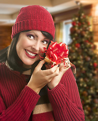 Image showing Woman Holding Wrapped Gift in Christmas Setting