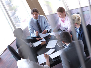 Image showing business people group on meeting at bright modern office