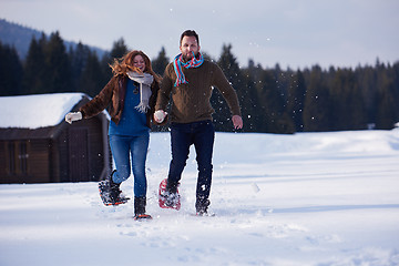 Image showing couple having fun and walking in snow shoes